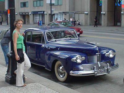 Me standing by a blue car